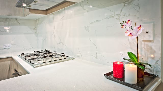 Kitchen counter with candles and a flower