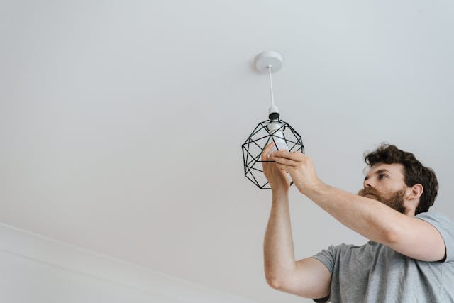 Person installing a light bulb