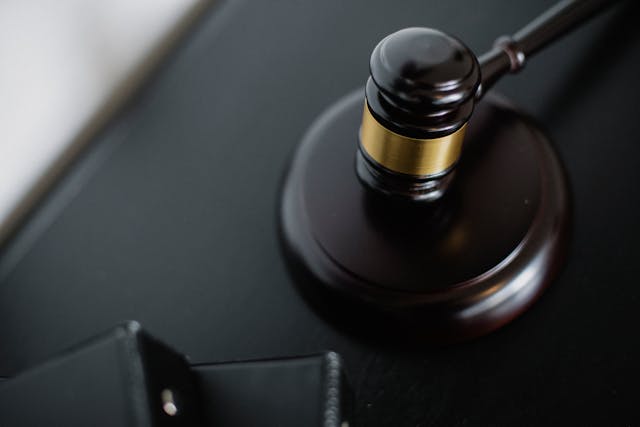 a black and gold judge gavel on a desk