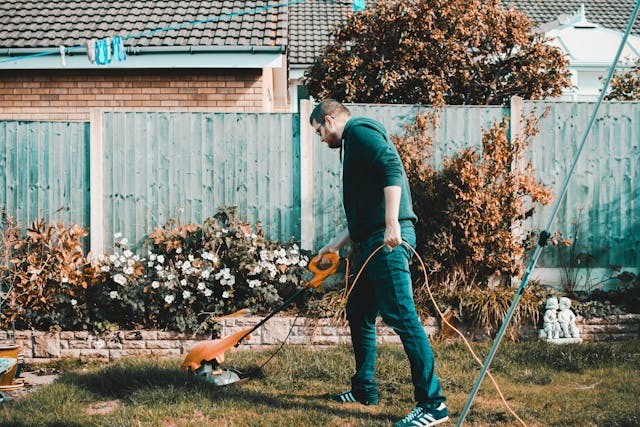 Person using an electric lawn mower